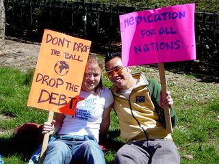 These two participants held up signs saying "Don't drop the ball, drop the debt!" and "Medication for all nations..."