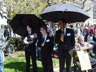 People from the Boston Direct Action Project dressed up as vampires, with black suits, white faces, vampire fangs, and large black umbrellas, pretending to be World Bank PR representatives.