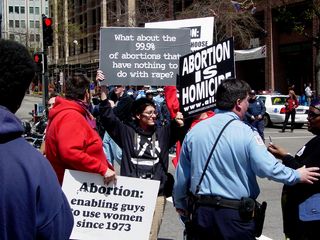 Counter-protesters at 18th and H Streets NW, in the northeast corner of the park, holding up pro-life signs. As I said before, I found it odd that they chose a rally on globalization for their venue.