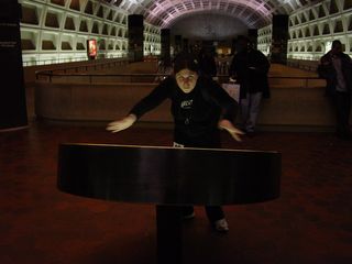 The Amazing Ann Schumin (a good magician name, don't you think?) pretends to cast a spell over the lighted map of the station on the Greenbelt platform at L'Enfant Plaza.