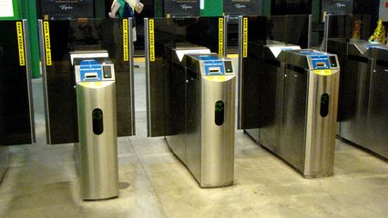 Faregates at Copley. When exiting a T station, since the MBTA charges a flat fare for rail travel, you simply walk through the gates, and the gate pops open when it detects someone heading towards it.