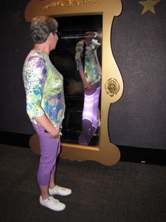 Mom takes a moment to pose in front of a funny mirror.