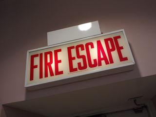 One thing about Chicago is that the exit signs are different. Local ordinance requires that exit signs be built to very specific requirements, which makes them unique within the city. You also get "stairs" signs, and in this case, in a store on the Magnificent Mile, there is a "fire escape" sign.