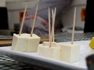 Tofu samples on toothpicks.