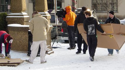 The cardboard coffins were being assembled by volunteers on the side of the rally site. Some of the coffins were covered with black cloth, and others were covered by American flags.