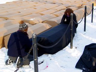 The cardboard coffins were being assembled by volunteers on the side of the rally site. Some of the coffins were covered with black cloth, and others were covered by American flags.