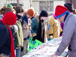 In a section of the park near to the street, a vendor was selling politically-themed bumper stickers.