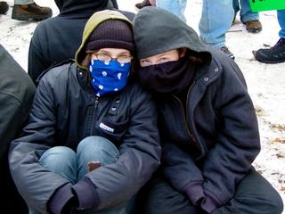 Meanwhile, these two masked women sat on the ground while waiting for the march to get moving. Interestingly enough, these two remembered me from the Million Worker March.