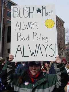 I ended up spending the rest of the march with this woman and her friend, as the march continued. She carried her Bush-Mart sign, and I marched alongside.