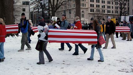 Demonstrators bring the coffins into McPherson Square.