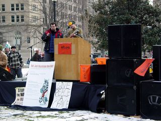 At McPherson Square, sound equipment and a stage had been set up and musicians were playing, with left.org as the primary sponsor.