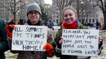 With double-sided signs, these people have a message, and they mean it!