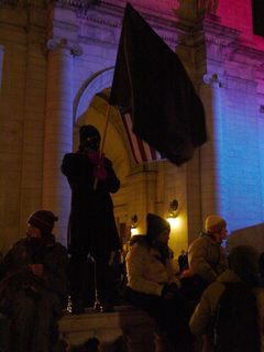 The person who seemed to be the icon of our demonstration was a small woman wearing the standard black mask, holding up a large black flag nearly as tall as she was.