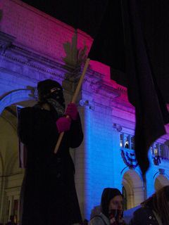 The person who seemed to be the icon of our demonstration was a small woman wearing the standard black mask, holding up a large black flag nearly as tall as she was.