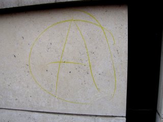 Anarchy sign drawn on the IFC building. At the time, I believed this to be a chalk marking, but upon later examination of the photo, this was probably ink.