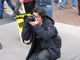 A photographer takes a moment to shoot a photo of the assembled crowd.