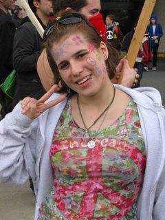 This woman is decked out from head to toe in various symbols representing the peace movement, from peace signs drawn on her face to flowers on the lining of her Chucks.