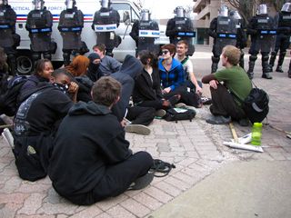 After having been marching more or less continuously for more than eight miles, the group that had originally gathered for the black bloc leaving from Farragut Square finally got a chance to sit down and chill out for a while.