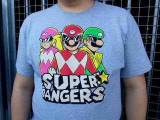 I spotted this shirt at College Park station on August 3. I thought it was pretty awesome, mixing Power Rangers and Super Mario. A little research revealed that this shirt was designed for the July 2015 1Up Box shipment, and therefore is not sold in stores.