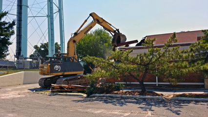 On August 4, while Elyse and I were on our way down to Virginia see Matthew and then go trainspotting, we noticed some work going on at the former KFC by Glenmont Metro station. This restaurant closed in May 2011 after a Ride On bus made contact with the front of the building. On this particular day, they were finally demolishing the building. The property, owned by Metro since 1982, is now vacant, pending further discussion on the area's redevelopment.