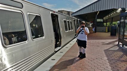 Elyse photographs a 7000-Series train at King Street.