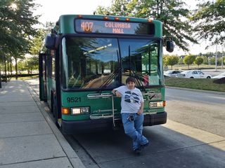 Elyse poses for a photo with bus 9521, a Gillig Low Floor. This is a former Howard Transit bus. Howard Transit is one of the predecessor entities to RTA, which was formed as a consolidation of several smaller local agencies.