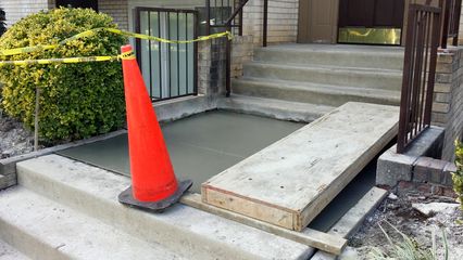 This was the way we accessed my apartment building on October 7. They replaced one of the concrete landings leading to the entrance due to cracking, and we walked over this little bridge. Funny thing was that for all of the work, the contractors that put it in did a terrible job, causing water to pool in the location. So they had to redo it again, but the fix worked.