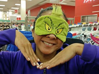 On December 2, after a swimming session, my friend Suzie and I went to the Target in Rockville. Here, Suzie is posing with a Grinch sleep mask - first making a grinchlike face, and then making a happier face.