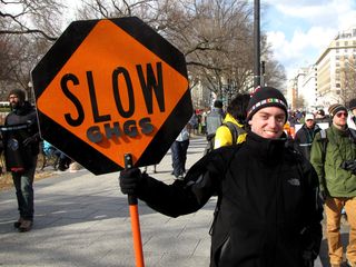 Two sides of a highway worker's "SLOW/STOP" sign.