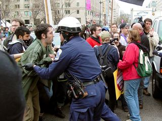 However, as far as the cops were concerned, we were not about to stay there, and they used their sticks to shove people out of the street and into McPherson Square.