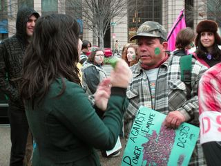 Samantha discusses things with the gentleman who lined up the march and started it going the wrong way.