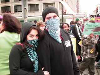 A masked couple poses for the camera.