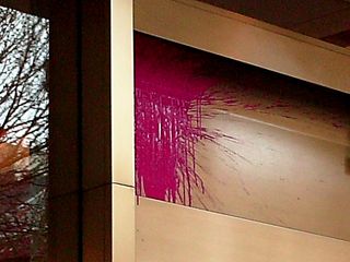 A "paint bomb", filled with pink paint, found its target on the face of the building.