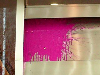 A "paint bomb", filled with pink paint, found its target on the face of the building.