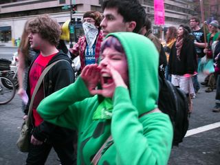 A woman shouts along the march route.