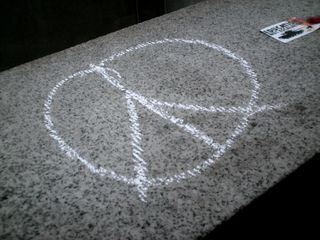 Peace sign drawn on the south entrance to Dupont Circle station.