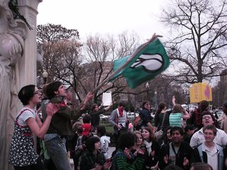 Waving a peace flag from the center of the fountain.