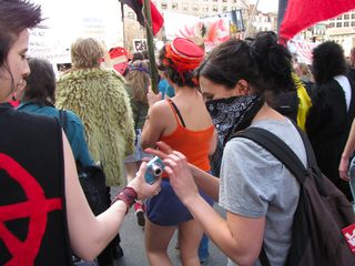 Handing off the camera to a masked demonstrator, and then... taking a picture!