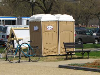 The world's nastiest port-a-potties, having gone a wee bit too long between servicings. Thank goodness that men don't actually have to touch any of the hardware to use the facilities.