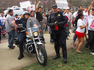 Officer Schauf handles the cans of pepper spray, which in themselves created a hostile situation.