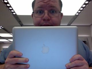 Holding up the MacBook that I'm taking to the Genius Bar to get checked out.