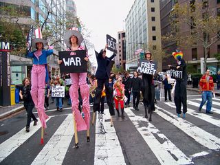 The people on stilts led the way.