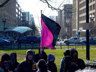 Meanwhile, a pink-and-black anarcha-feminist flag also made an appearance.
