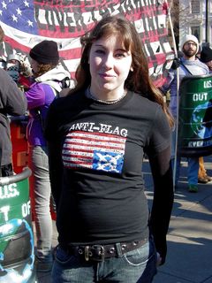 A woman wears a shirt for the Pittsburgh-based band Anti-Flag, showing an upside-down flag with various slogans written along the flag's stripes. Even if you're unaware of the band or its views, the shirt certainly makes quite a political statement on its own.
