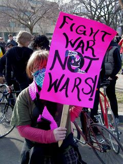 This woman carries a sign with an interesting spin: "Fight war, not wars." That's deep. Fight against the concept of war, rather than wage war.
