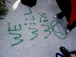 "We will win" and an anarchy sign is spray painted in green onto the Capitol steps.