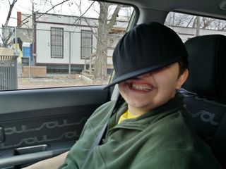 On December 13, I was out with Elyse practicing a few bus routes in the car.  I got a few silly photos of her wearing a baseball cap while we were out.