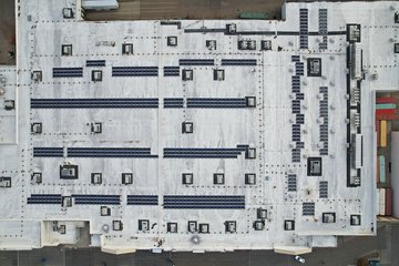 The roof of the Walmart in Austintown.  Note that only the rightmost part of the building contains skylights.  This is consistent with a conversion store, where the original part of the building dates from the period when Walmart built stores with drop ceilings and no skylights, while the grocery expansion contains an open truss ceiling and skylights.