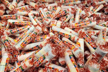 Rolls of Rockets candy in a bin at Bulk Barn.  Rockets is the name for what is known as Smarties in the States.