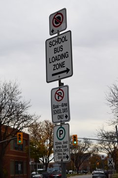 A cluster of school-related parking signs on Victoria Avenue for Immaculate Conception Catholic Elementary School.